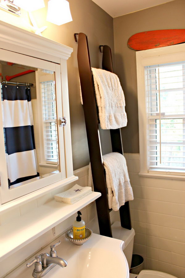 This ladder towel rack over the toilet was used for towel storage and visual height for the small space. 