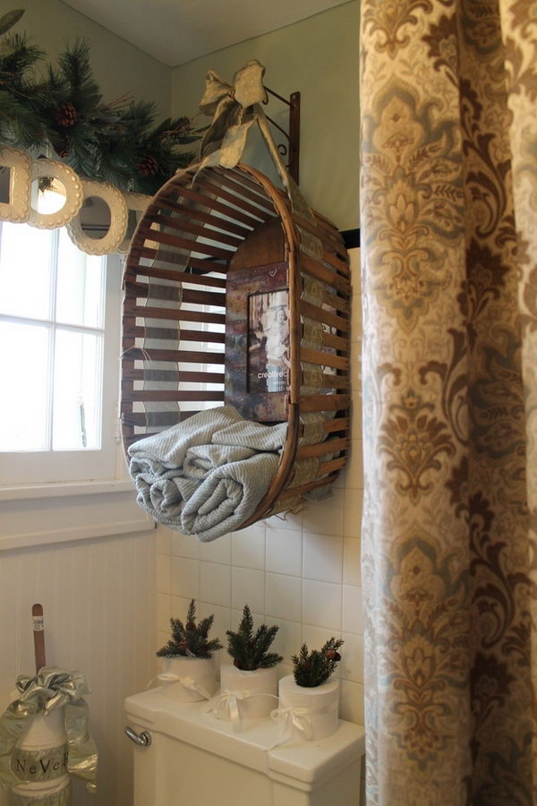 Upcycle an old wooden basket into a bathroom towel holder over the toilet. 