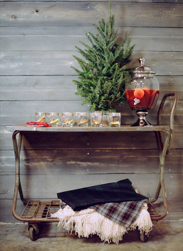 Rolling Drink Cart. Create this rolling drink cart with mini tree, mulled wine cocktail decanter and throw blankets in creamy and cozy plaid tartan down below. This rolling cart drink station is really amazing for its mobile style. 