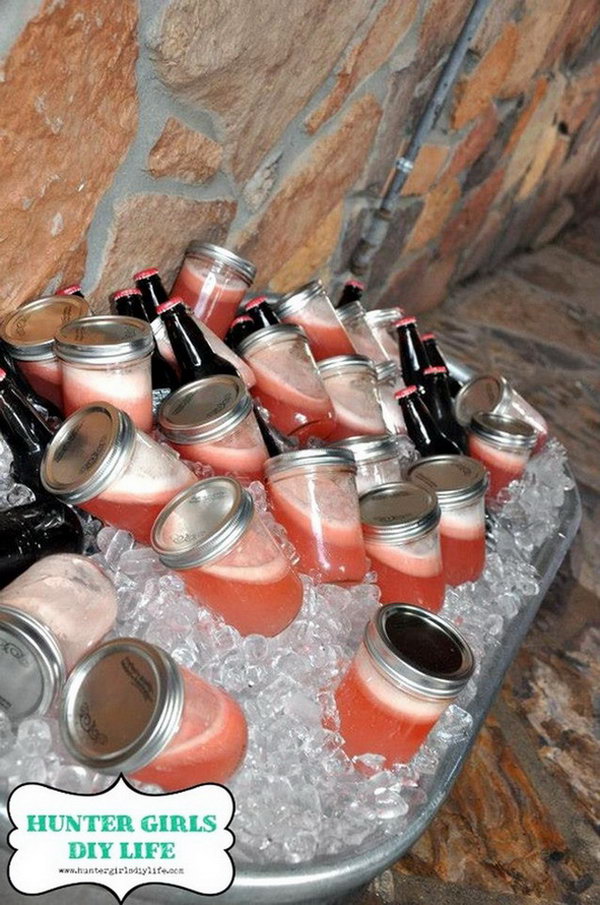 Premade Jam Jar Drink Station. It's so creative to fill jam jars with premade strawberry and vanilla shakes for beautiful colors and fresh flavor on a summer day. Simply display them together with the bottled root beer in an iced horse trough. 