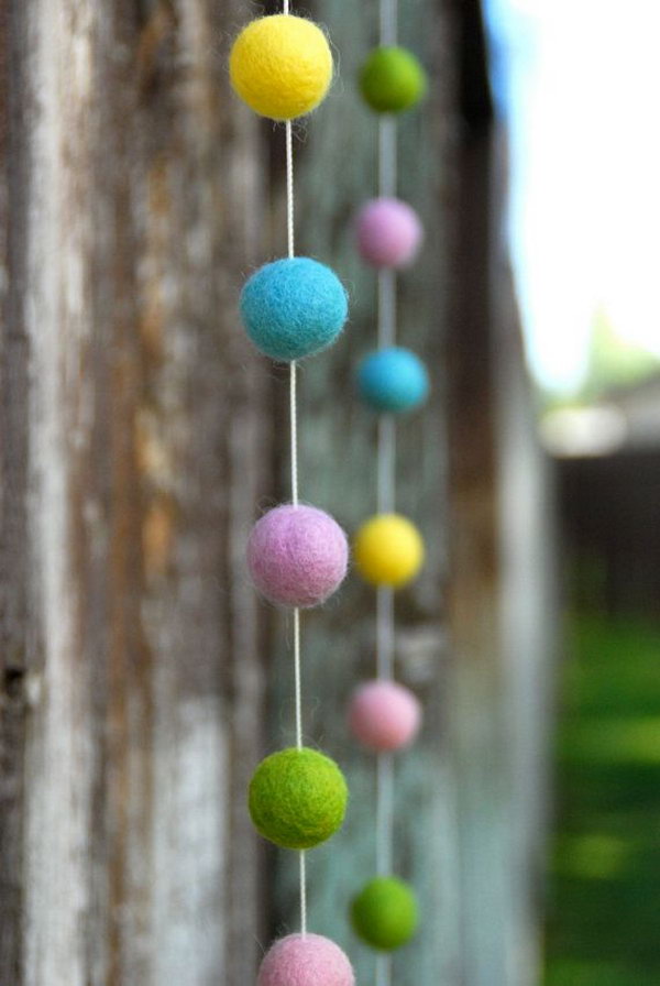 Spring Easter Felt Ball Garland. This kid friendly table setting gives off a spectacular spring display with wheat grass in egg halves, daisies and purple tulips tucked in. Finish this off with colorful buckets filled with treats for kids. 