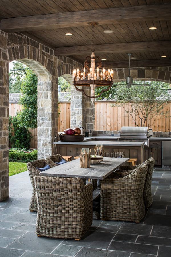 The chandelier adds some mystery and romance to this outdoor kitchen. The soft, warm lighting bright up the space and adds irresistible charm to these spring spots. It really fits with the foundation of rocks and grey brick. 