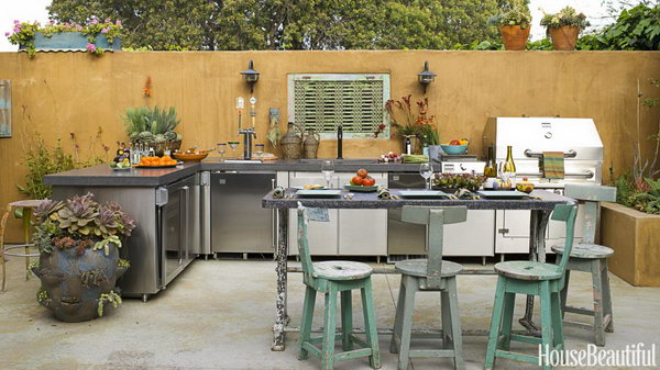 There's a feeling of some age and maturity to this outdoor kitchen designed by Sandy Koepke in Manhattan Beach, California. It is really a great place for a party with a stunning outdoor fireplace, earthy dicers and beer on tap. 