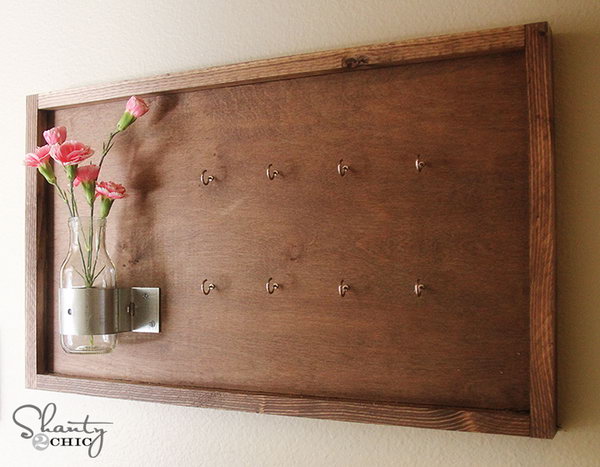 DIY Key Holder Decorated with Vase and Flowers. This version of a key holder features an old board but decorated with vases and flowers. It looks good on the wall, replacing beautifully any painting or artwork, but holding your keys as well. See more 