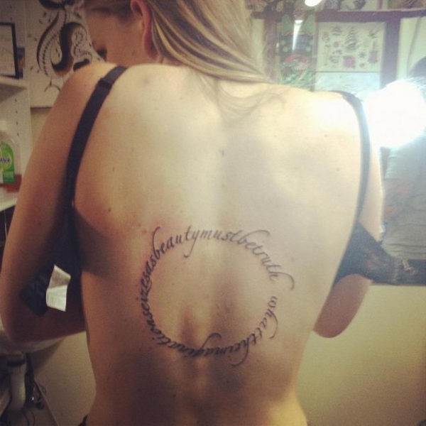 round-shaped-text-tattoo-on-back-8