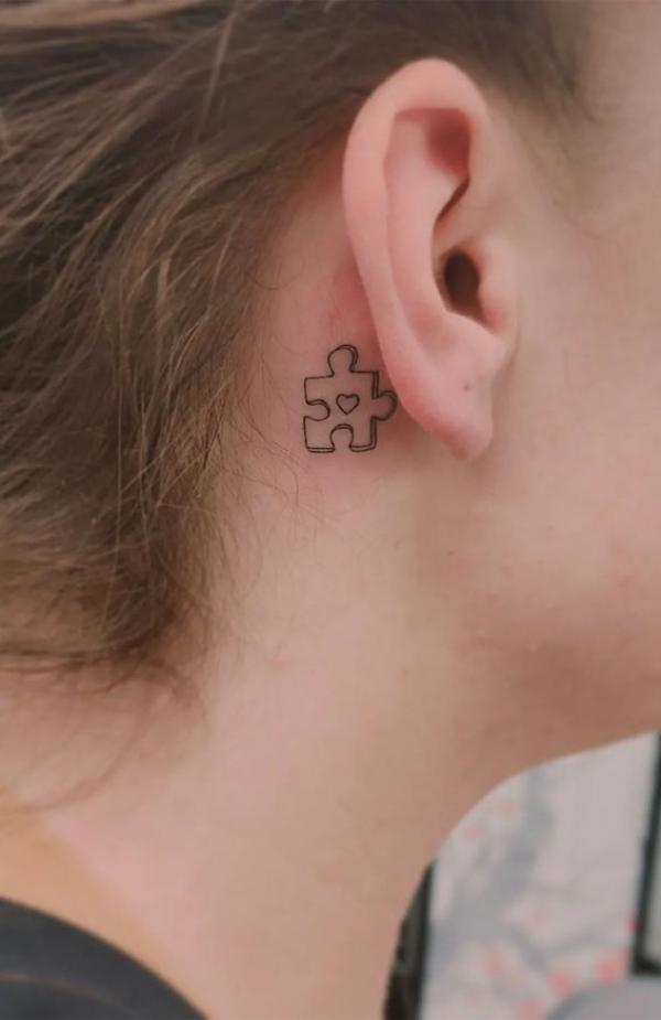 Puzzle line work tattoo behind ear