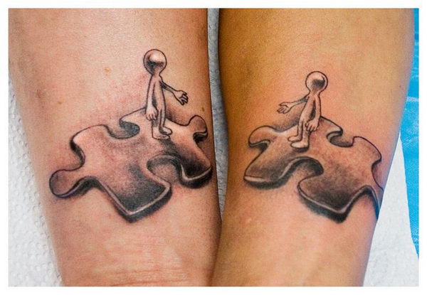 Matching puzzle piece tattoo on both inner forearms