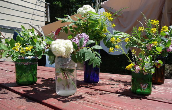 Wine Bottle Vases. Cut the wine bottles in half and use the bottle bottoms to make vases.