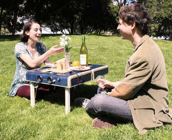 Suitcase repurposed into portable picnic table, with legs that fold inside.