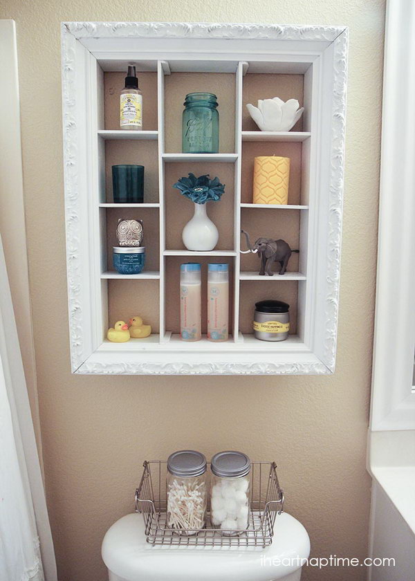 Repurpose an old picture frame into an over the toilet storage unit.  