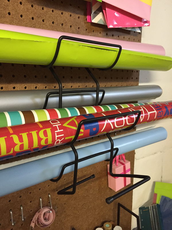 Place these wine racks on the pegboard to hold rolls of gift wrap. 