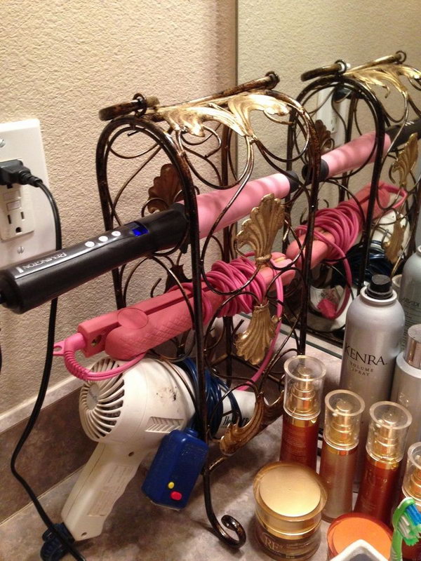 Wine Rack Hair Dryer Holder. Use a small and decorative wine rack to store your hair tools. It helps in keeping the bathroom counters clean and beautiful. 