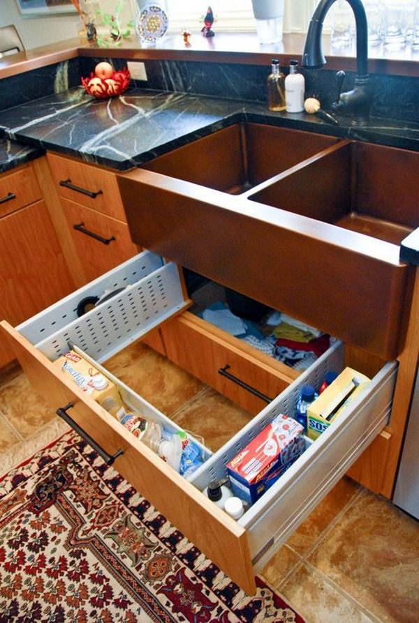 Sink Drawer Surround Plumbing. The sink drawer is adjustable to fit around the plumbing and disposal below. It's a great spot for all the sponges, dish soap, trash bags and cleaning supplies that usually get lost in the dark corners. 