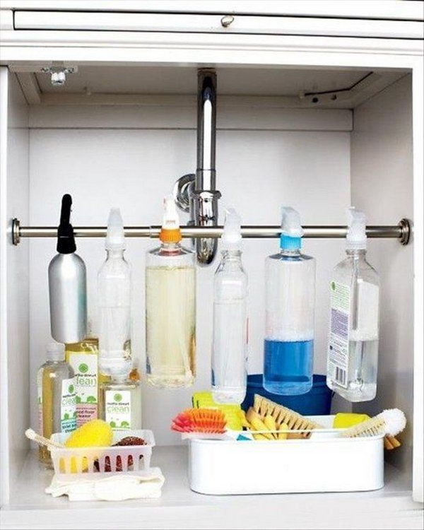 Suspend Spray Bottles Under Sink. Install a curtain rod across the cabinet. Suspend the spray bottles by their spray triggers, and free up storage space for bathroom or kitchen essentials. 