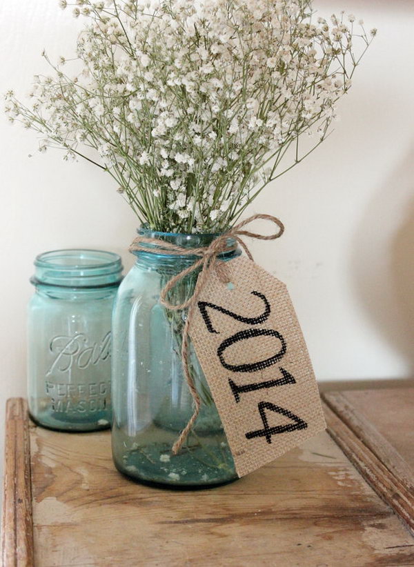 Rustic Burlap Table Tag. Put a bundle of flowers in the mason jar vase, tie rustic burlap tag around the neck of it to create the barn graduation party decor with a fresh flavor.