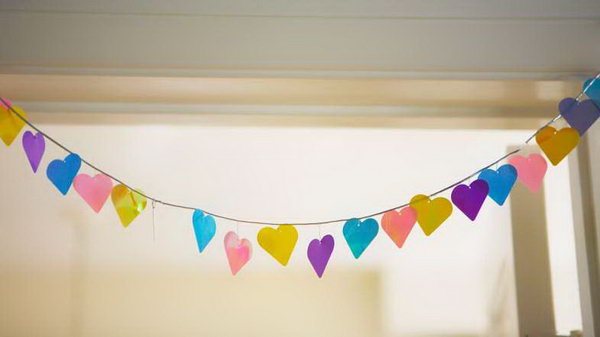 Colorful Paper Wedding Garland. For beautiful backdrop decorations with low cost, you can try this easy made garland using oversize paper punch to make cutouts in shapes as you like. String them through to get your wedding reception dolled up with this beautiful backdrop.