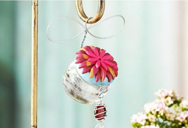 Hummingbird Feeder. Paint the lid of the jar, glue plastic flowers for beautiful decor at the top. Hang it around the hook. Replace your out of date hummingbird feeder with this exquisite one for practical use as well as beautiful decor.