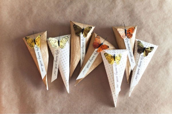 Butterfly Cady Cones. Make cone with cardstock. Fill it with candies, popcorn, rice or whatever you like, fold top, add tag and connect with butterfly in body of cone to finish off this elegant piece of art in a cheap way.