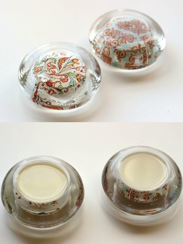 DIY Paperweights from Glass Candle Holders. This is a fun and inexpensive project to reuse old glass jar lids into amazing paperweights. All you need is a little Mod Podge and some pourable resin from the dollar store to set the glass. See the tutorial here.