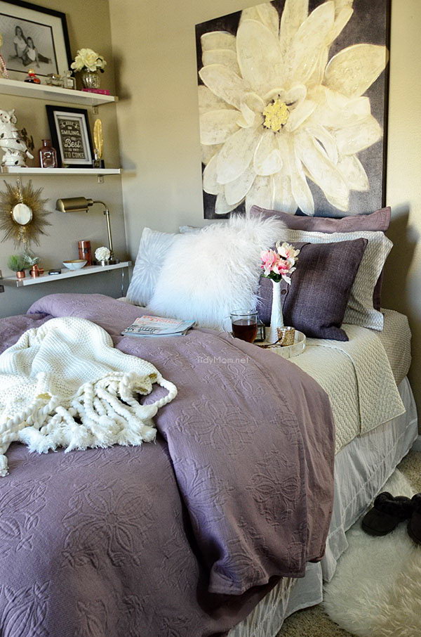 Purple Wall Art: The oversized wall art and curtains used in this bedroom is a tricky way to accent the pastel feel of this bedroom.