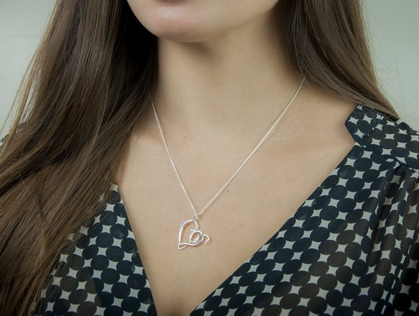 Heart of Treble and Bass Clefs Silver Necklace . This unique jewelry makes a nice gift for a music lover. Having the heart be comprised of a treble clef and bass clef is very unique.