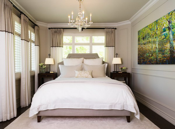 Stripes on the walls, curtains and headboard make this small gray bedroom look bigger.