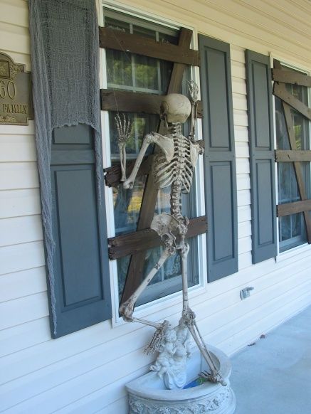 Boarded Up Windows Using Cardboard And Skeleton Proped To Look Like It's Trying To Get In. 