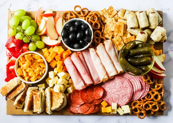 Kid Friendly Board with fruit, crackers, bread and chips. 