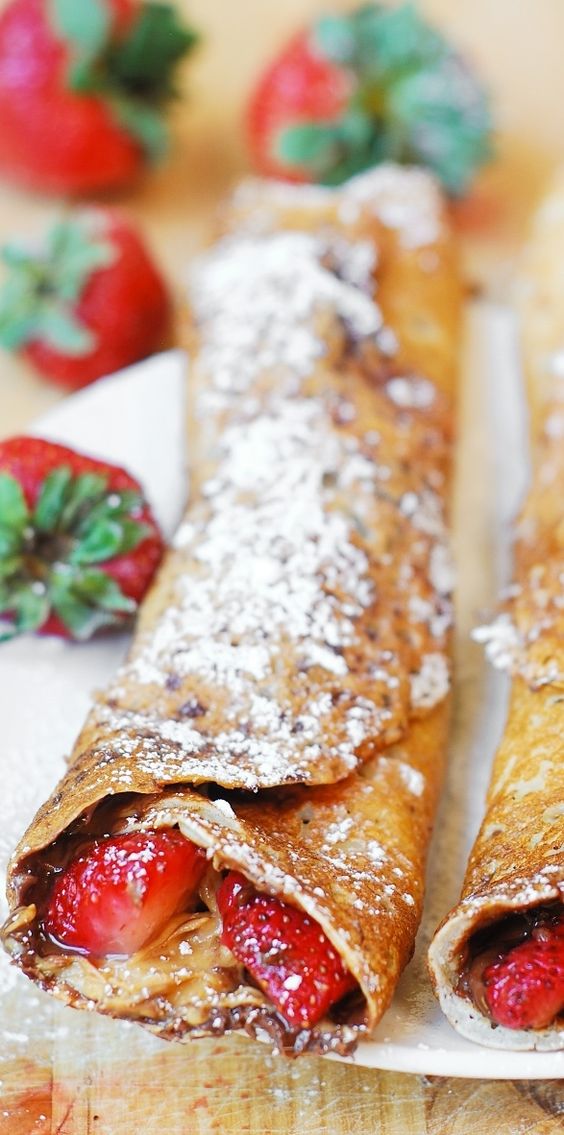 Peanut Butter and Nutella Stuffed Crepes with Strawberries in Syrup. 