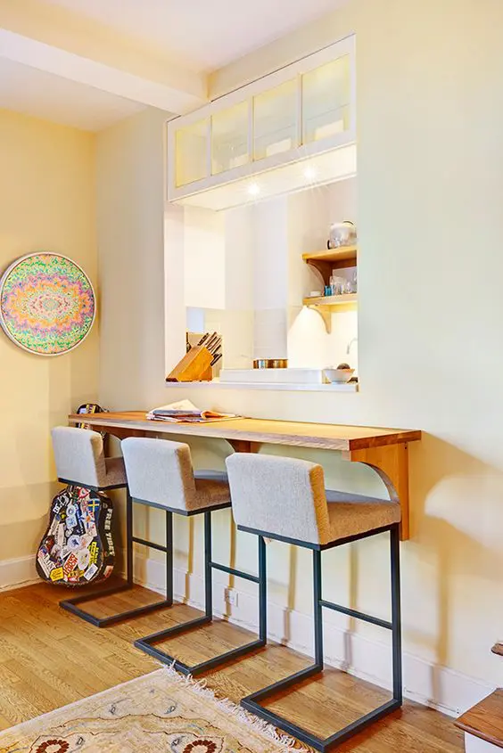 Cozy Breakfast Space with a Wooden Tabletop and Upholstered Stools. 