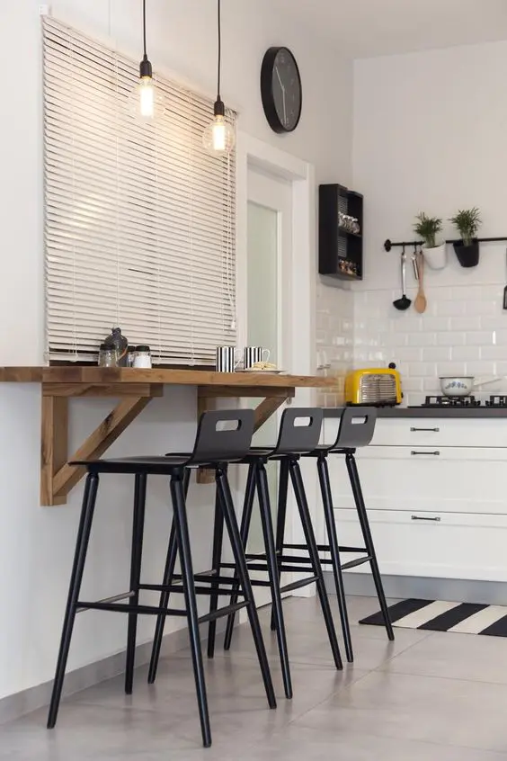 A Breakfast Bar with Roman Shades and a Wall-Mounted Tabletop. 