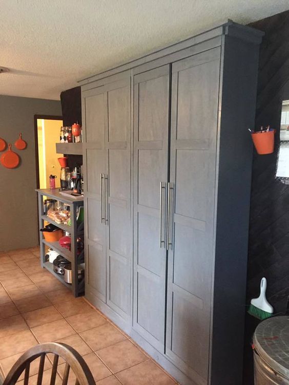 Organized Pantry with Cool Grey Floor to Ceiling Cabinets. 