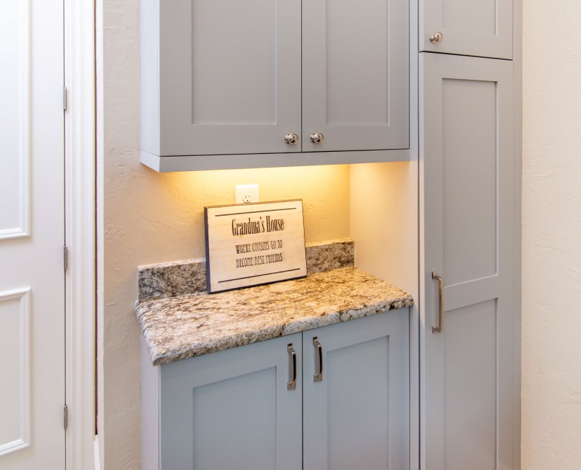 Soft Blue Floor to Ceiling Cabinets In Laundry Room. 